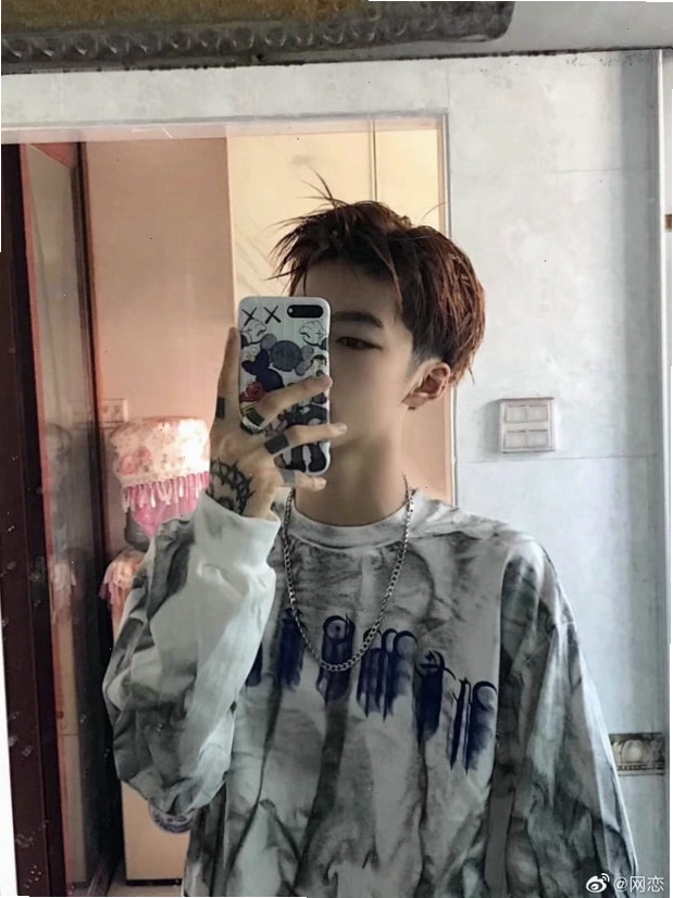 Boy sử dụng điện thoại di động để che mặt